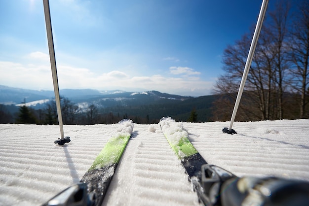 Skier legs in white snow beautiful winter mountain landscape and blue sky copy space background