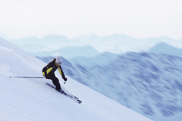 Skier skiing downhill in high mountains, Solden, Austria