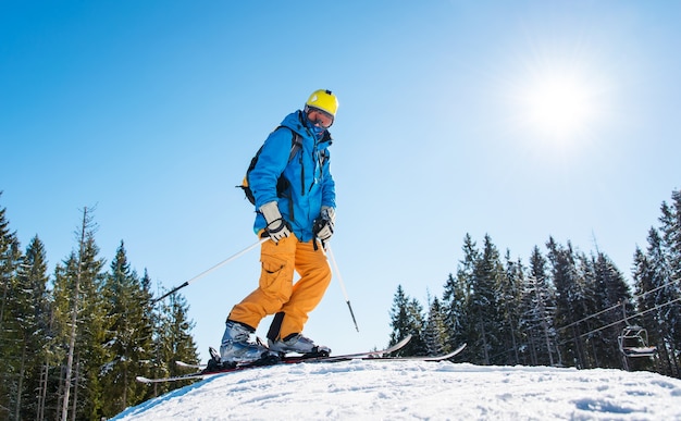 Skier on slope in mountains on winter day