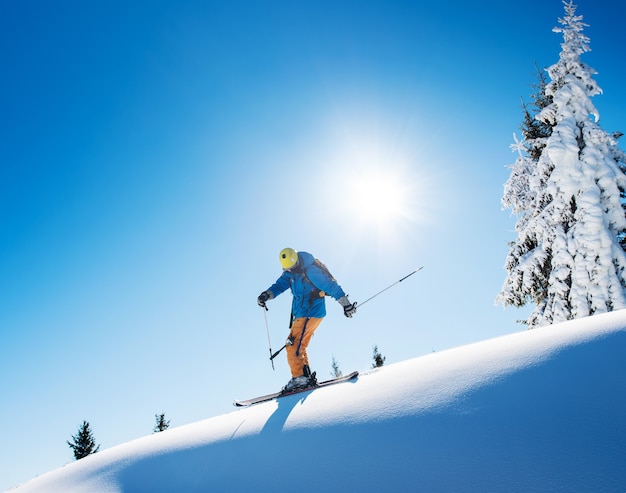 Skier on slope in mountains on winter day