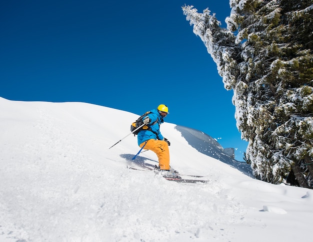 Skier on slope in mountains on winter day