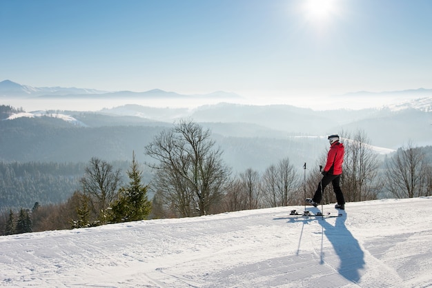 Skier on slope in mountains on winter day