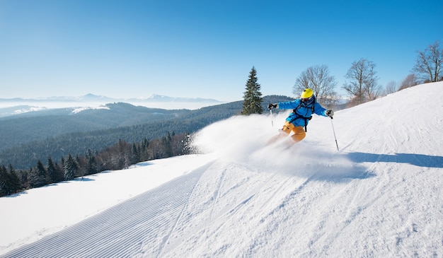 Skier on slope in mountains on winter day