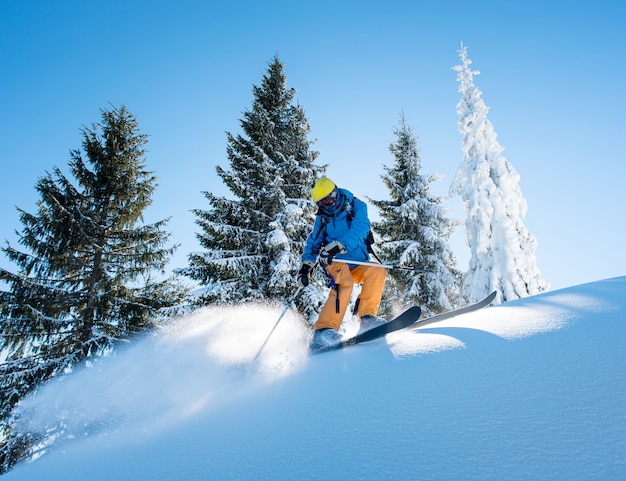 Skier on slope in mountains on winter day