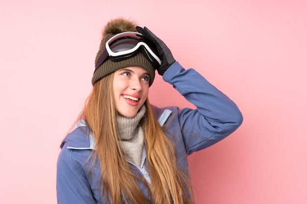 Skier teenager girl with snowboarding glasses background laughing