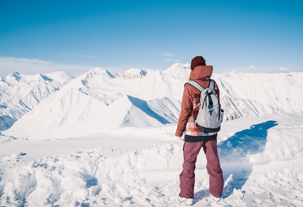 Skier on top of snow mountains at nice sun day. Caucasus Mountains in winter, Georgia, region Gudauri.