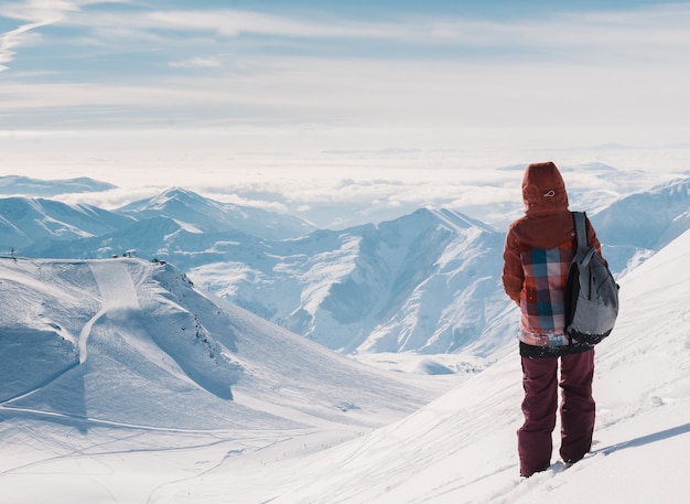 Skier on top of snow mountains at nice sun day. Caucasus Mountains in winter, Georgia, region Gudauri.