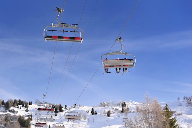 Skiers in a ski lift in alpine european resort 