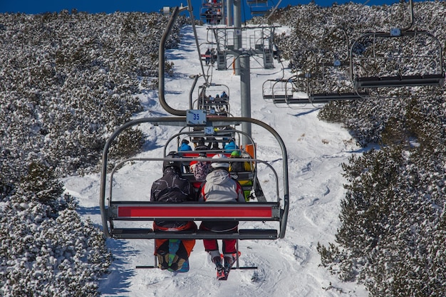 Photo skiers on a ski lift in the mountains