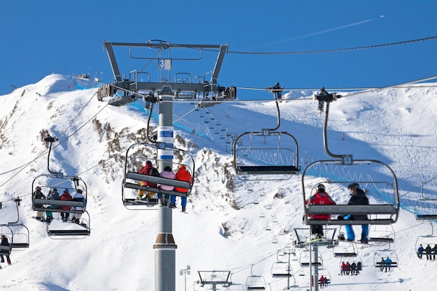 Skiers using the ski lift at Grandvalira ski resort in Pas de la Casa