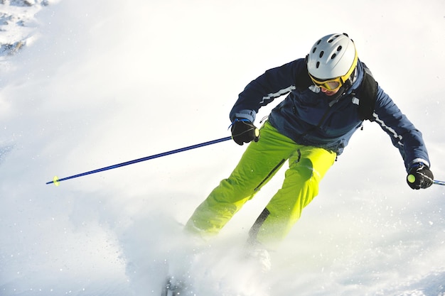 skiing on fresh snow at winter season at beautiful sunny day