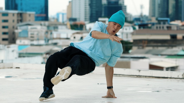 Фотография опытный кавказский танцор bboy практикует уличные танцы на крыше endeavor
