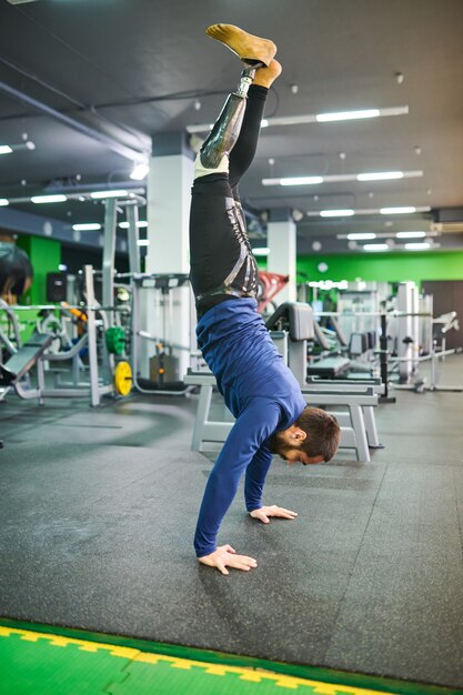 Skilled man standing on hands