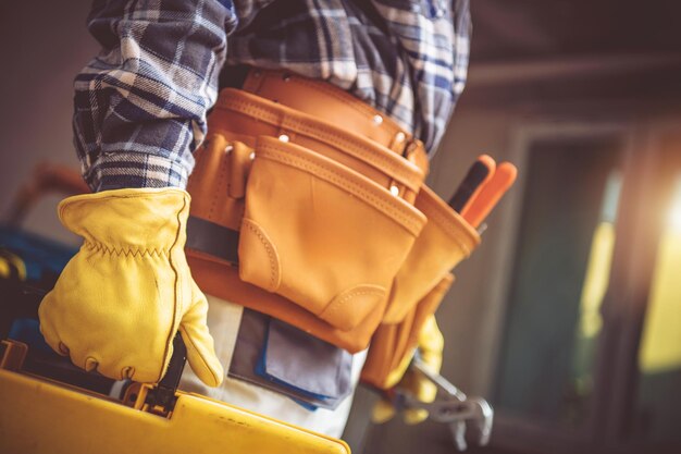 Skilled Tradesperson Using a Toolbox While Working Indoors in a WellLit Workshop