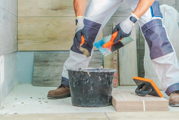 Skilled Worker Performing Tile Installation in a Modern Interior Space