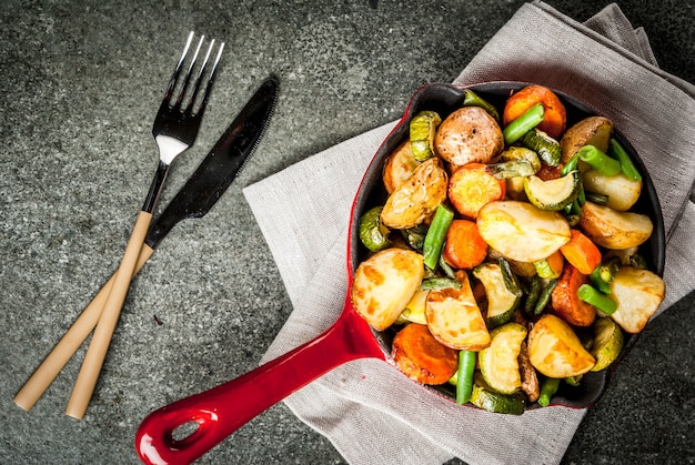 Skillet with  fried seasonal autumn vegetables (zucchini, potatoes, carrots, beans)