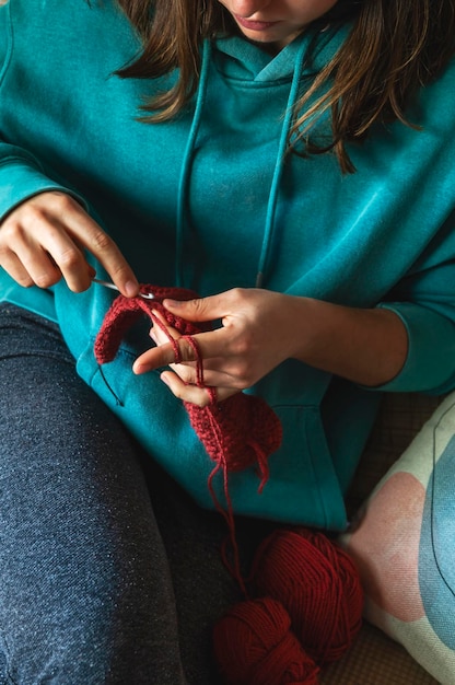 Skillful fingers of a young Caucasian girl holding crochet