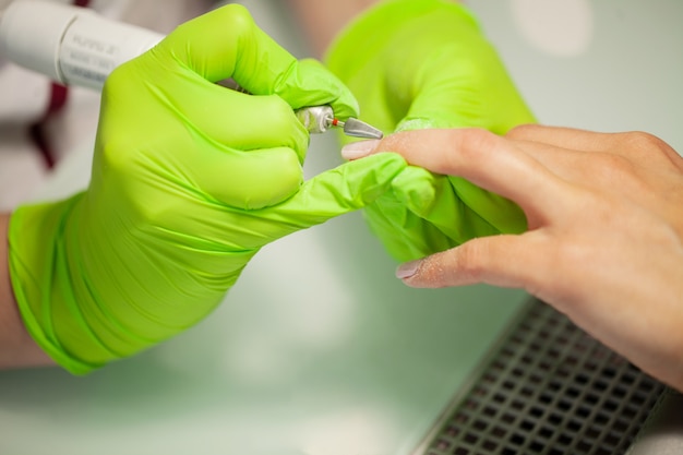 Skillful master of manicure holding file in her hands 