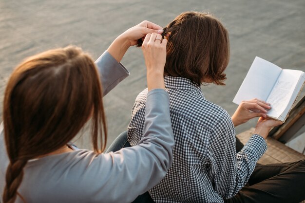 スキルのトレーニングと開発。女の子は三つ編みで髪をスタイリングする方法を勉強します。改善と経験