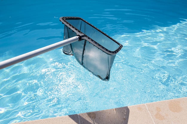 Skimmer net cleaning a swimming pool