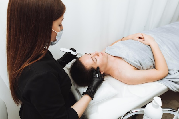 Skin care Closeup Of A Beautiful Woman Receiving An Ultrasound Facial Peeling Ultrasonic skin cleaning procedure Cosmetic procedures Cosmetology