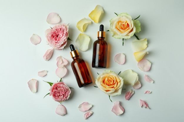 Skin care concept with essential rose oil on white