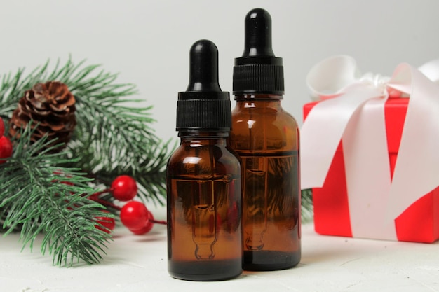 Skin care cosmetics bottles on a fir branches background