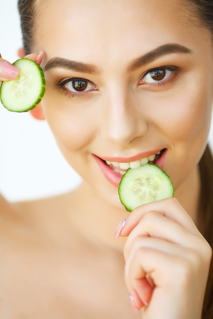 Skin Care. Happy Sexy Woman Posing With Slices of Cucumber in Her Hands. Beauty Treatment. Cosmetology. Beauty Spa Salon. Home spa