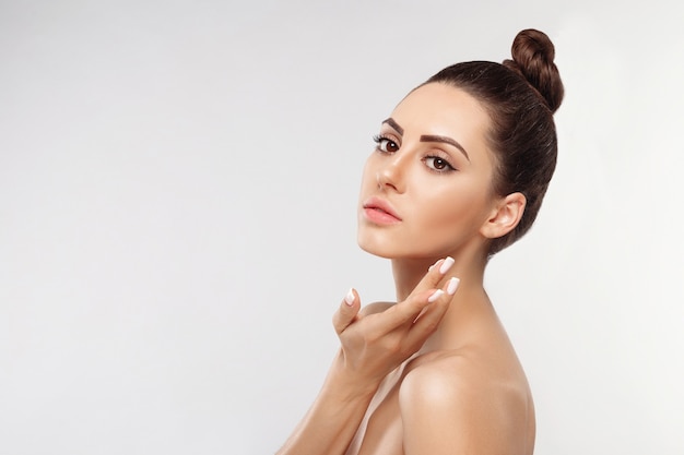 Skin care.Happy young woman applying cream to her face. Cosmetics.