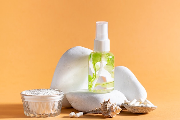 Skin care lotion or serum with sea plants extract and collagen on stone podium