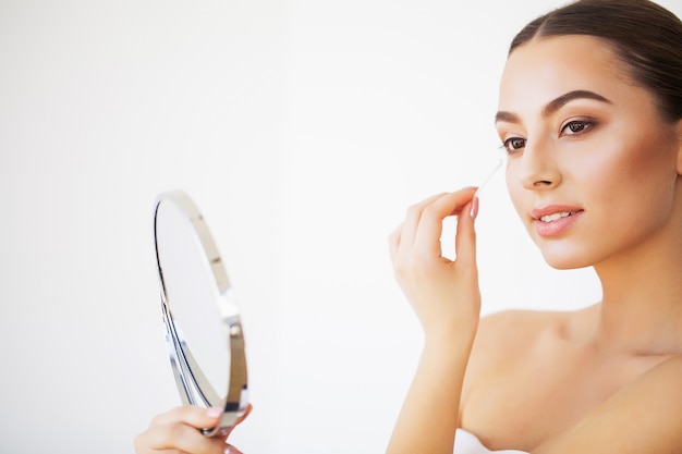 Skin Care. Portrait Of Sexy Young Woman With Fresh Healthy Skin Looking In Mirror Indoors