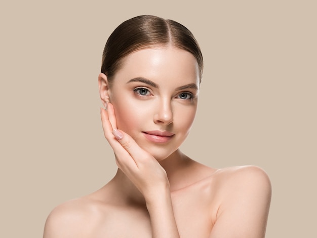 Skin care woman with hands portrait  skin closeup cosmetic age concept. Color background brown