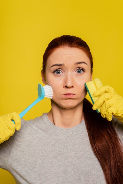 Skin Cleansing. Portrait Of Attractive Sexy Girl In Gloves Washing Face With Sponge And Brush. Closeup Beautiful Young Woman With Clean Soft Skin