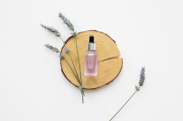 Skin oil and flowers flat lay