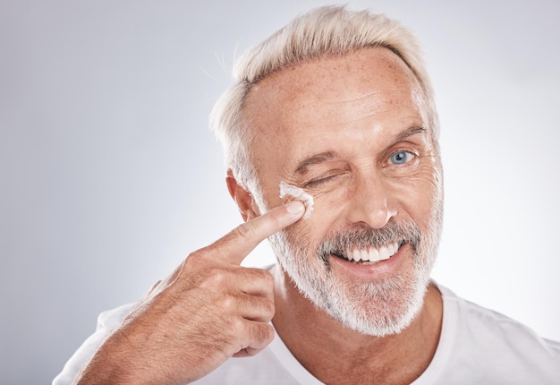 Skincare beauty and face cream of senior man on white background for spa wellness and dermatology Cosmetics grooming and elderly male with anti aging beauty products facial treatment and lotion