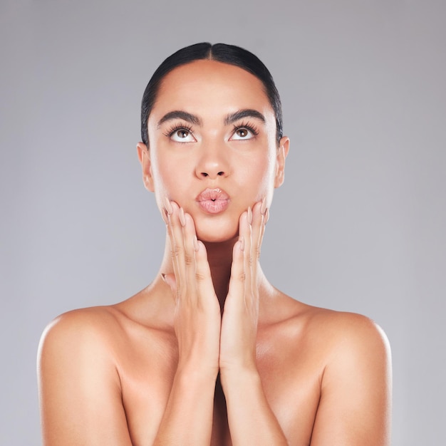 Skincare beauty and surprise face of a woman from Spain with healthy wellness and glowing skin Female model hands after cosmetic health dermatology and botox treatment or plastic surgery