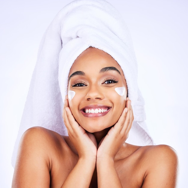 Skincare face cream and happy woman in studio with cosmetic wellness and application on grey background Facial portrait and female model with sunscreen lotion or mask spf or glowing skin