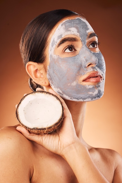 Skincare facial and woman with coconut in studio for face skin and hygiene treatment on brown background mockup Face model and girl with face product from nature nature extract and cleaning