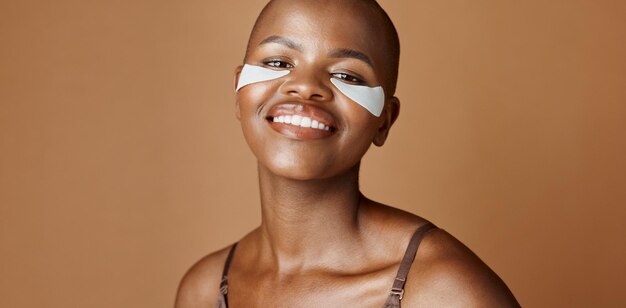 skincare health and face of black woman in studio with glowing natural and facial routine smile cosmetic and portrait of african person with dermatology beauty treatment by brown background