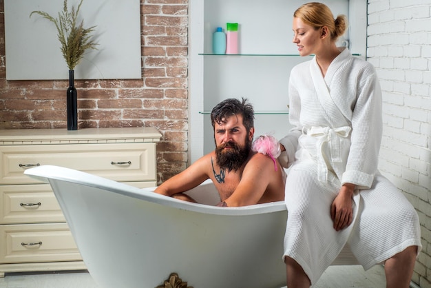 Skincare morning sexy couple couple of sensual girl and naked man trimming beard happy young couple