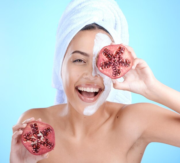 Skincare pomegranate and face mask portrait of woman happy about natural dermatology cosmetics excited person with sustainable spa beauty product for self care skin glow and facial blue background