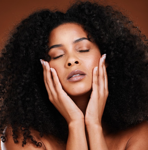 Skincare portrait or black woman with face makeup relax against an brown studio background luxury zoom or beauty girl model with glow from cosmetics health wellness or care for facial skin