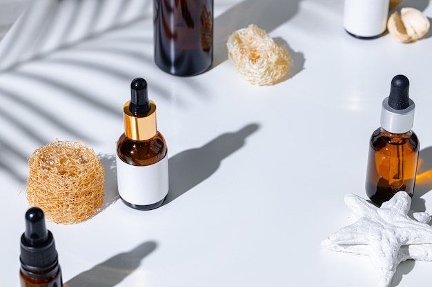 Skincare products containers on a white background with creative shadows close up