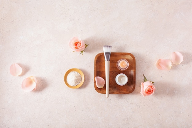 Skincare products and rose flowers. natural cosmetics for home spa treatment