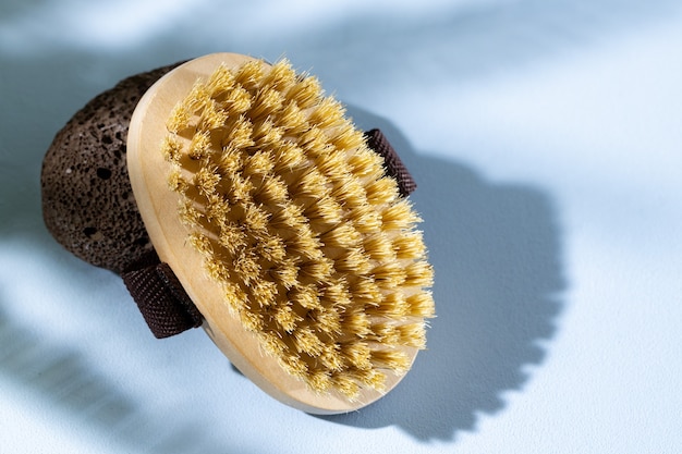 Skincare wooden massage brush on gray close up