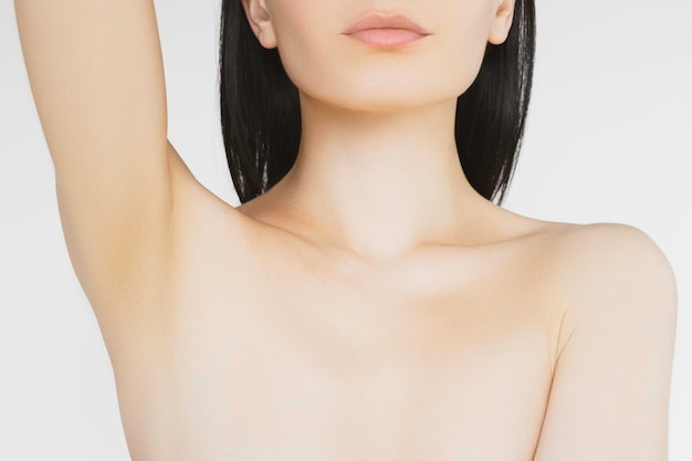 skinny brunette with pale skin shows clean armpits after hair removal procedure