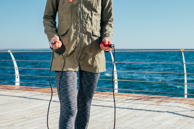 Skipping rope in female hands closeup