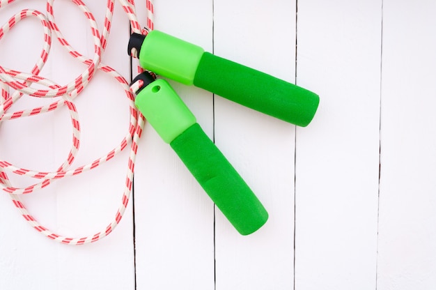 Skipping rope on a white wooden background