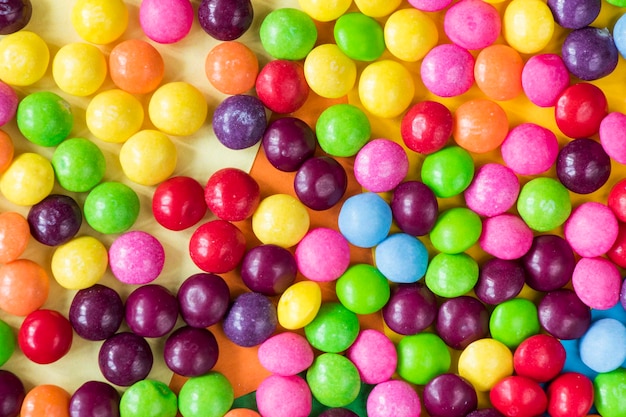 Skittles candy on the colorful table colorful sweet candy