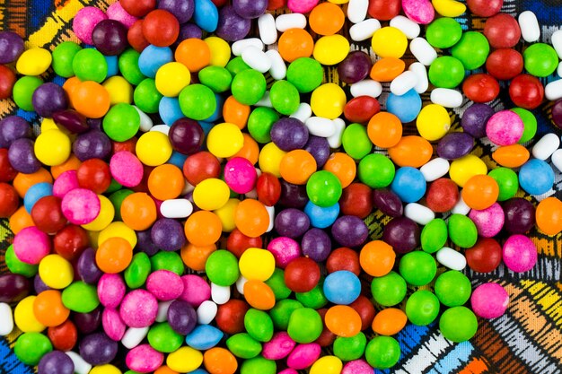 Skittles candy on the colorful table colorful sweet candy